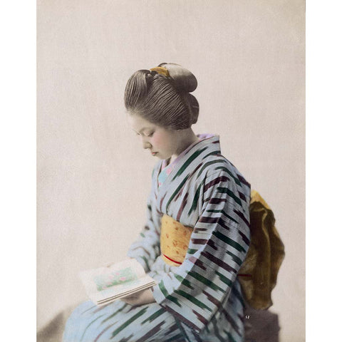 Young Japanese woman in kimono reading a book, 1890s